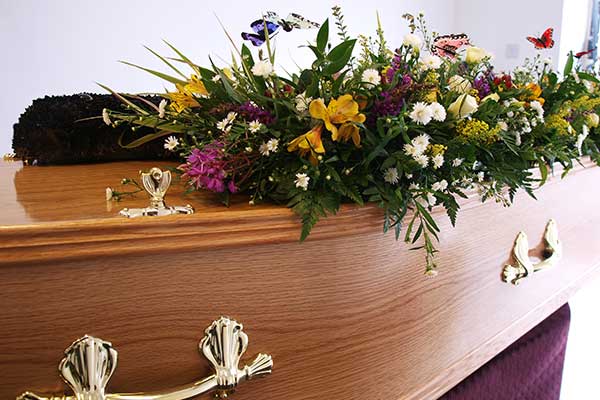 A wooden coffin with flowers
