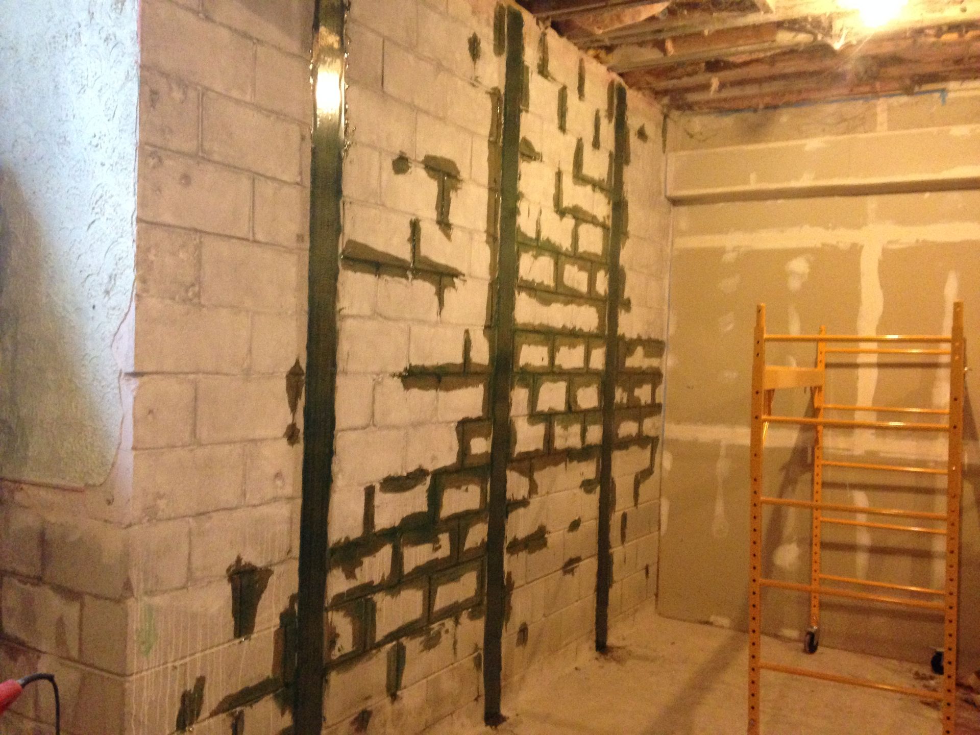 Basement wall with crack repairs and reinforcement.
