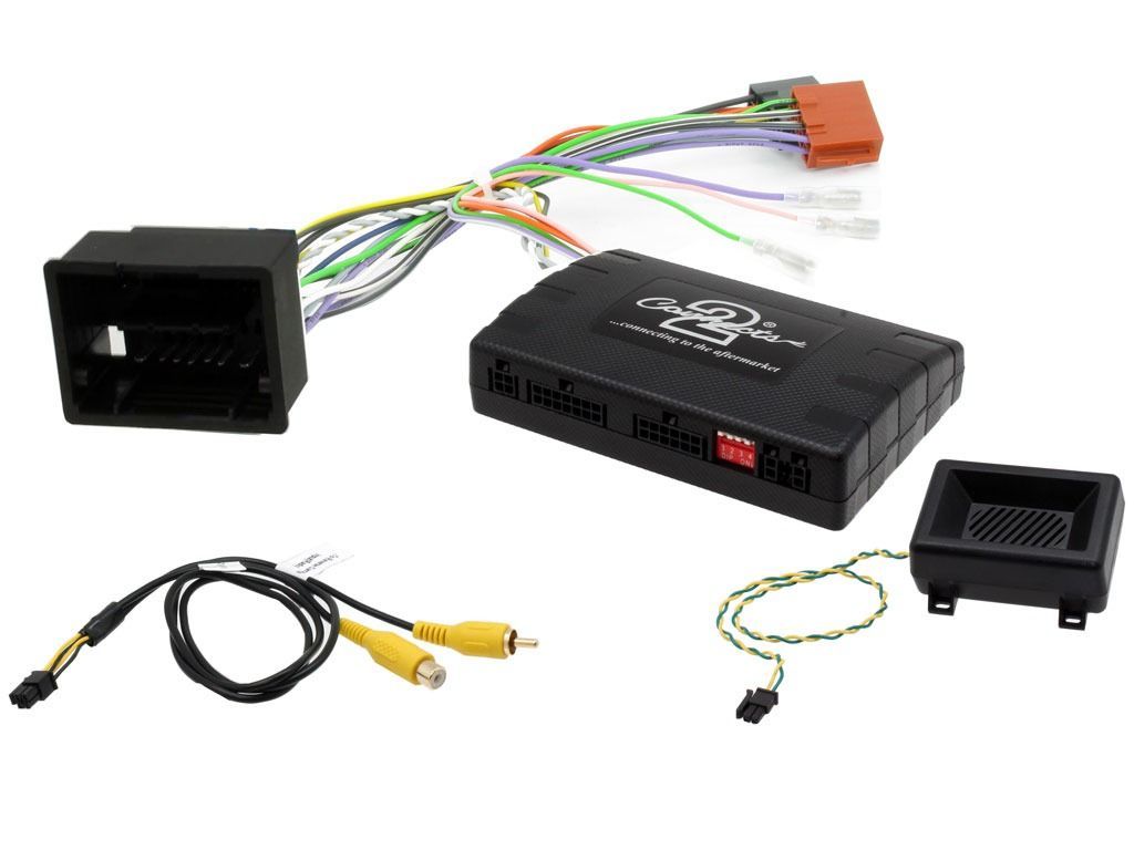 Car audio installation kit with wiring harnesses, a module, and a small tray.