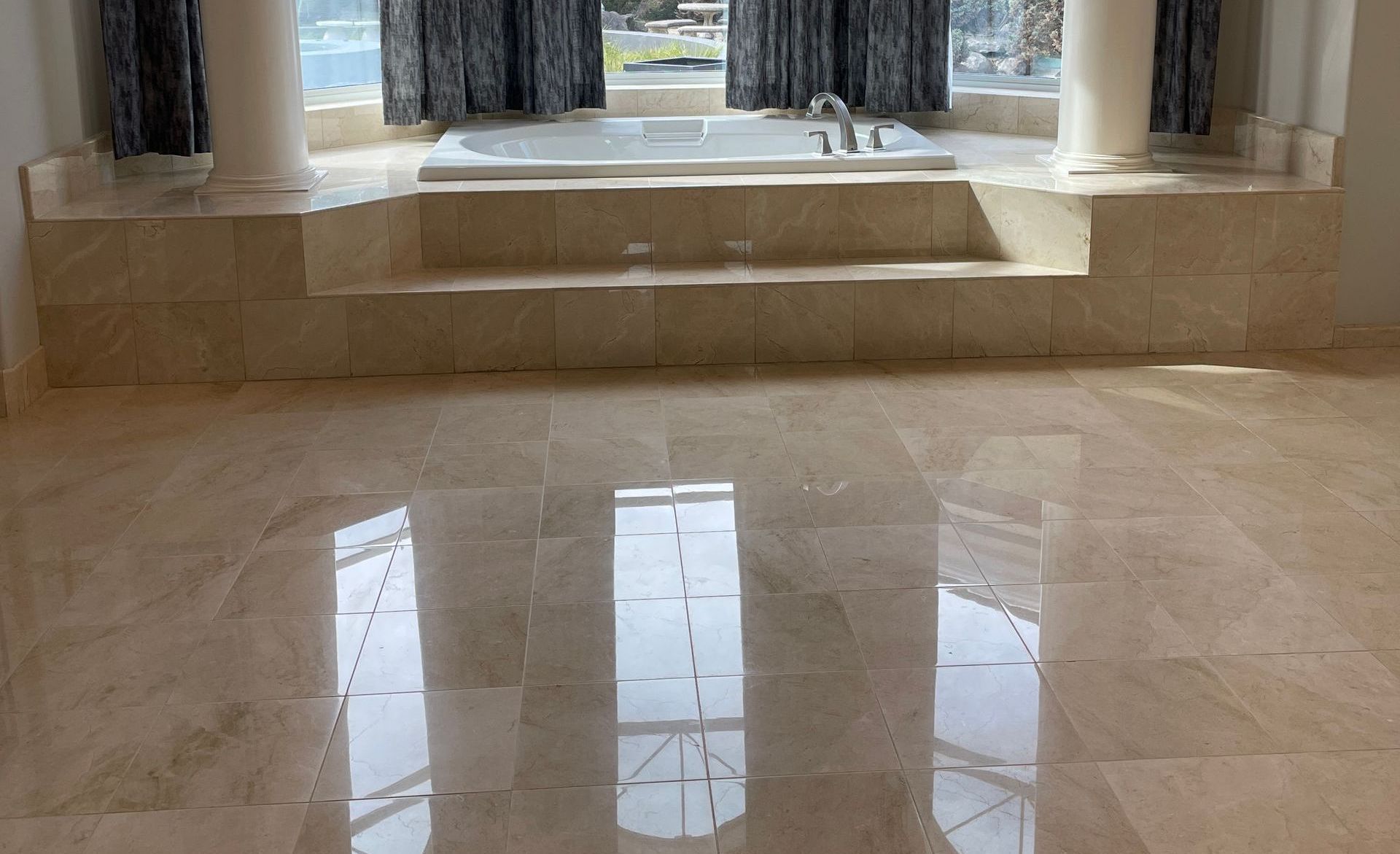 A bathroom with marble floors and a jacuzzi tub