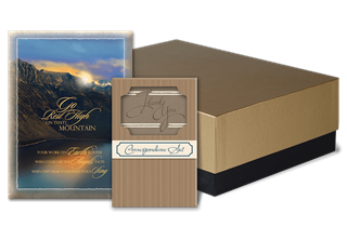 Books and decorative box, a mountain scene book cover, other book with decorative cut out. Golden and brown tones.