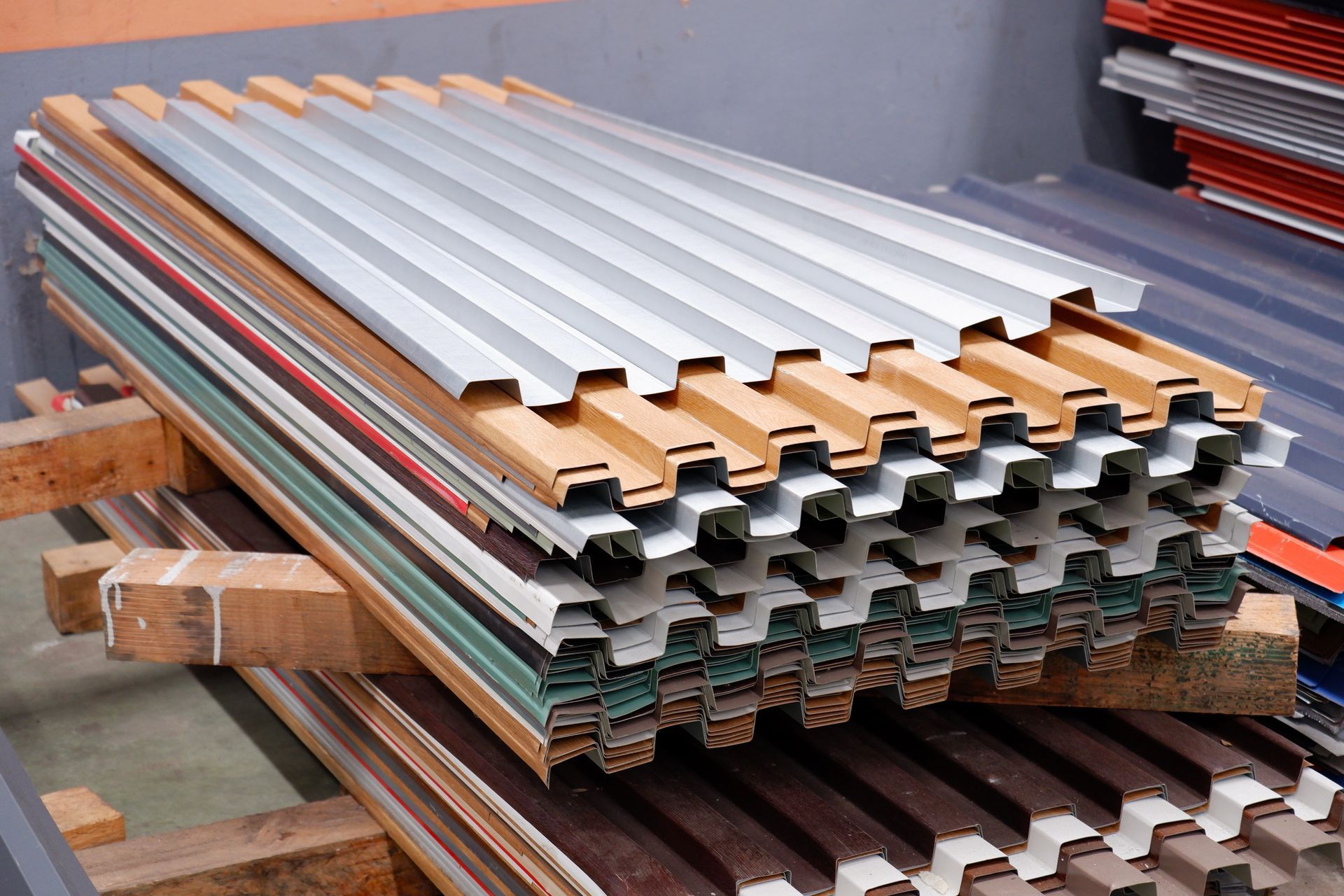 A stack of metal sheets sitting on top of wooden pallets.