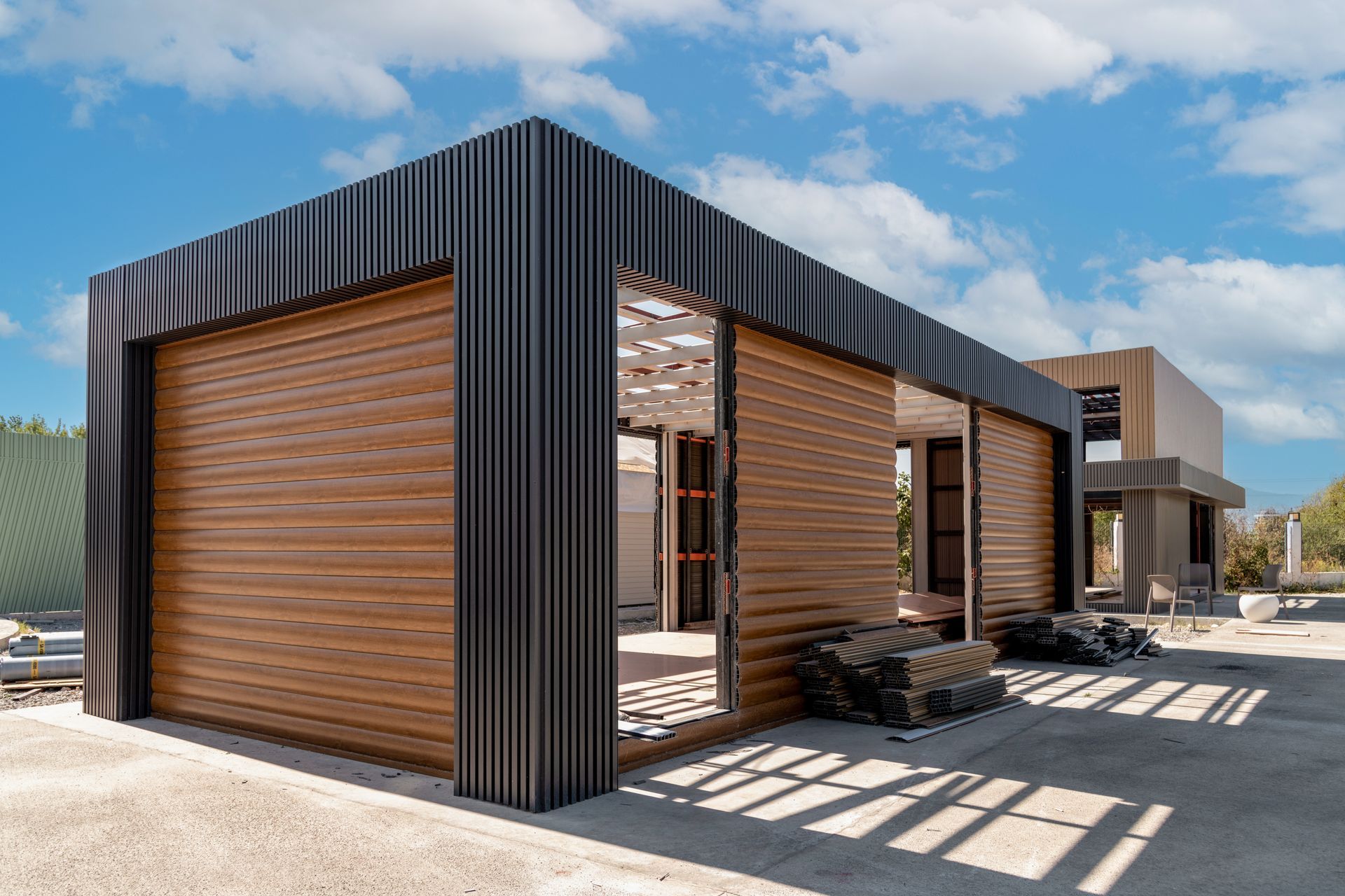 A house is being built with wooden siding and a metal roof.