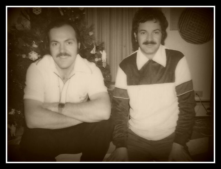 Two men are posing for a picture in front of a christmas tree