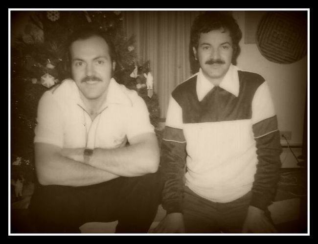 Two men are posing for a picture in front of a christmas tree Two men are posing for a picture in front of a christmas tree
