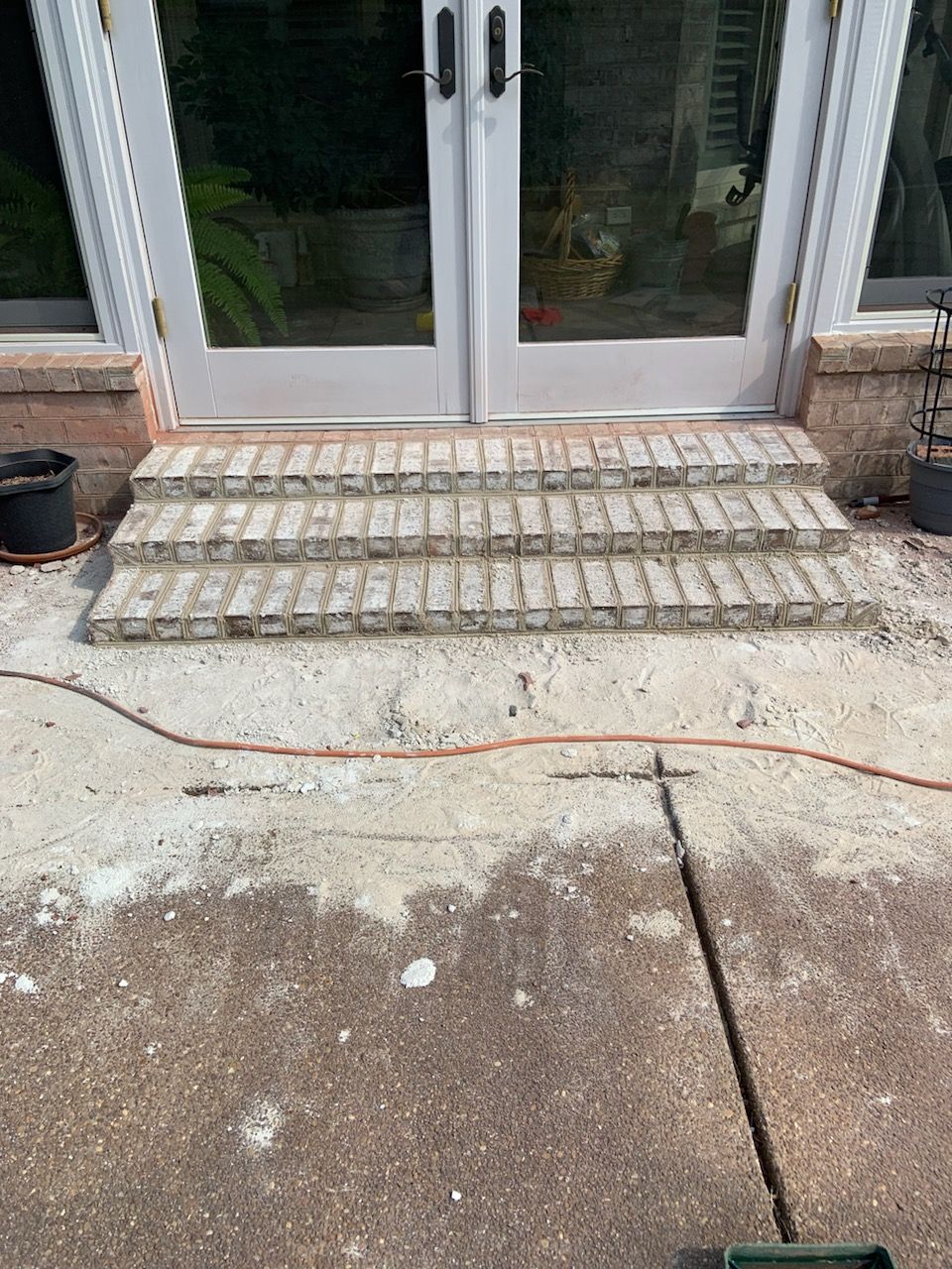 A set of brick steps leading up to a door.