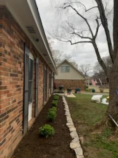 A brick house with a stone walkway leading to it.