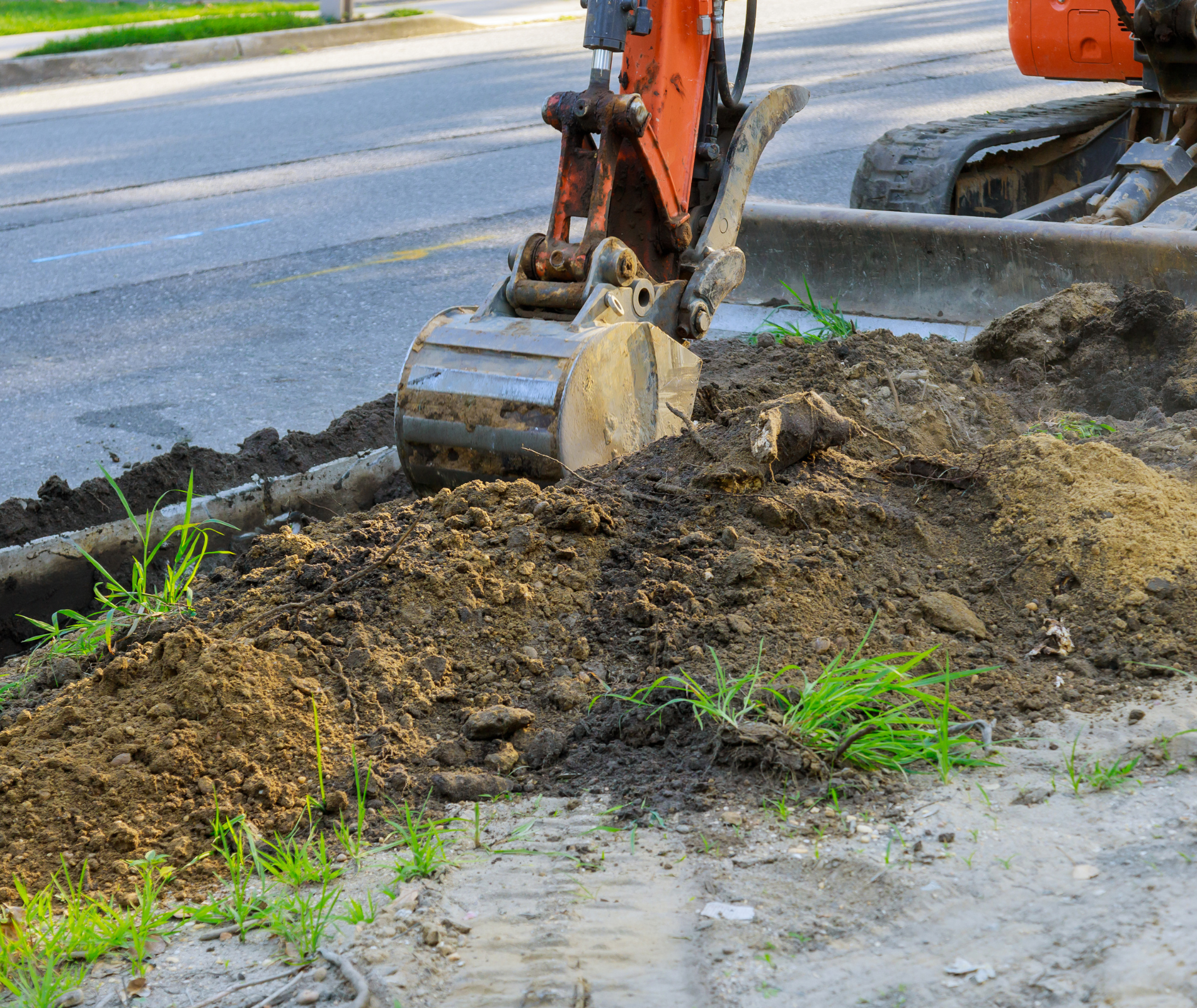 a bucket of dirt is being poured into a hole .