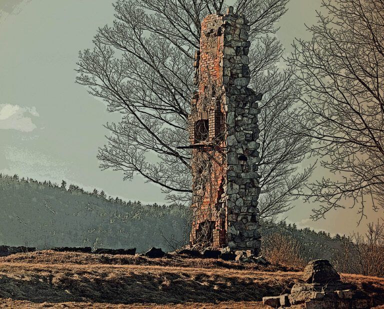 a stone tower with a tree in the background