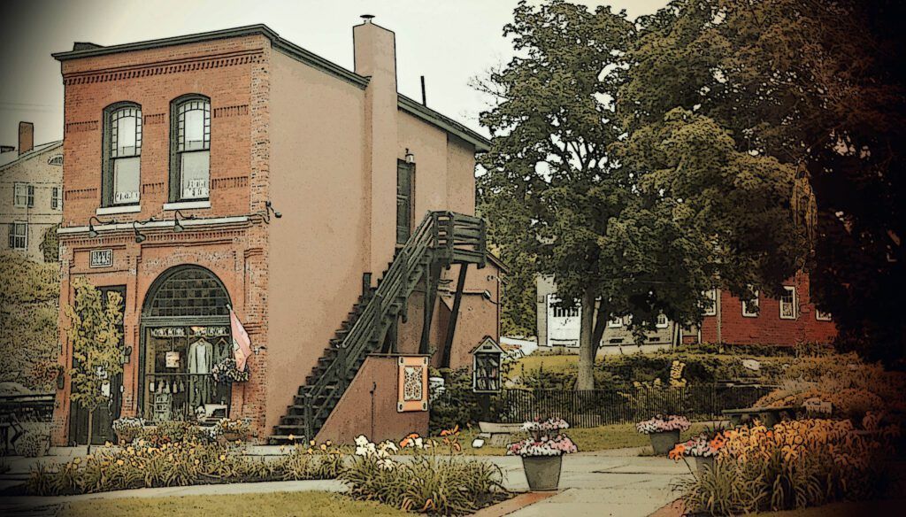 a brick building with a staircase leading up to the second floor in Brandon, VT