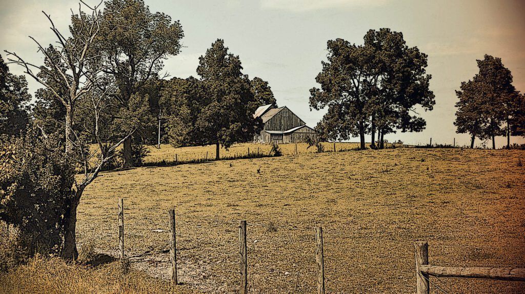 a barn sits in the middle of a field surrounded by trees in Bridport, VT