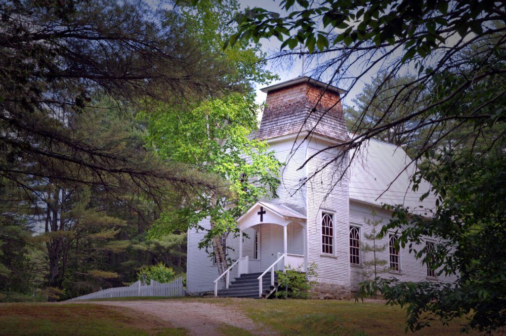 a white church with a cross on the front of it