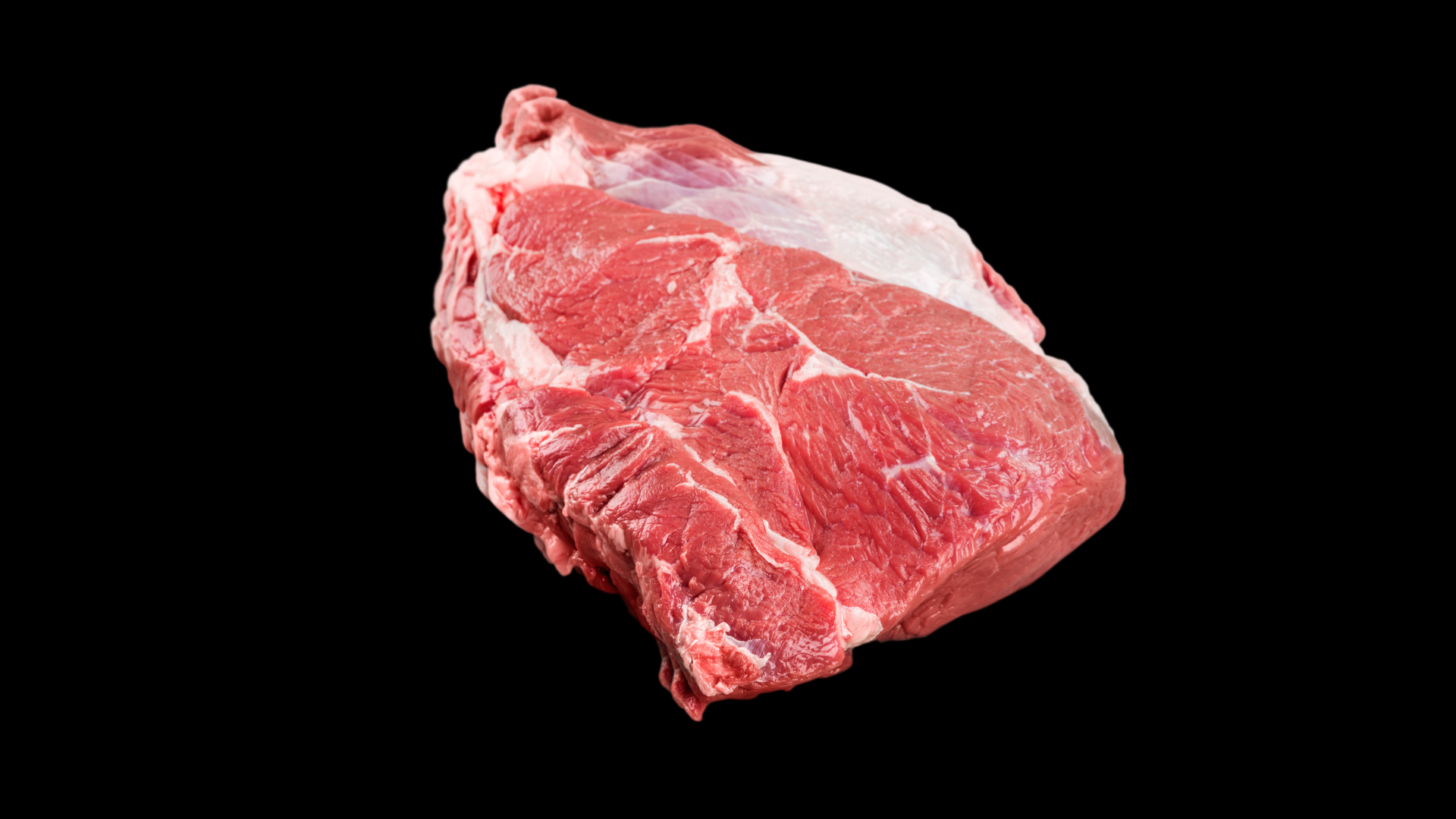 A piece of raw beef on a black background.
