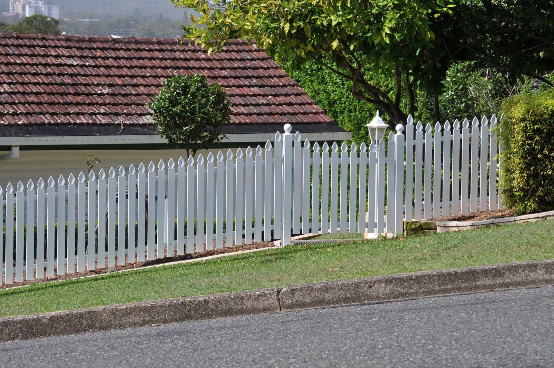 A white picket fence in front of a house — Fabricator In Coffs Harbour, NSW