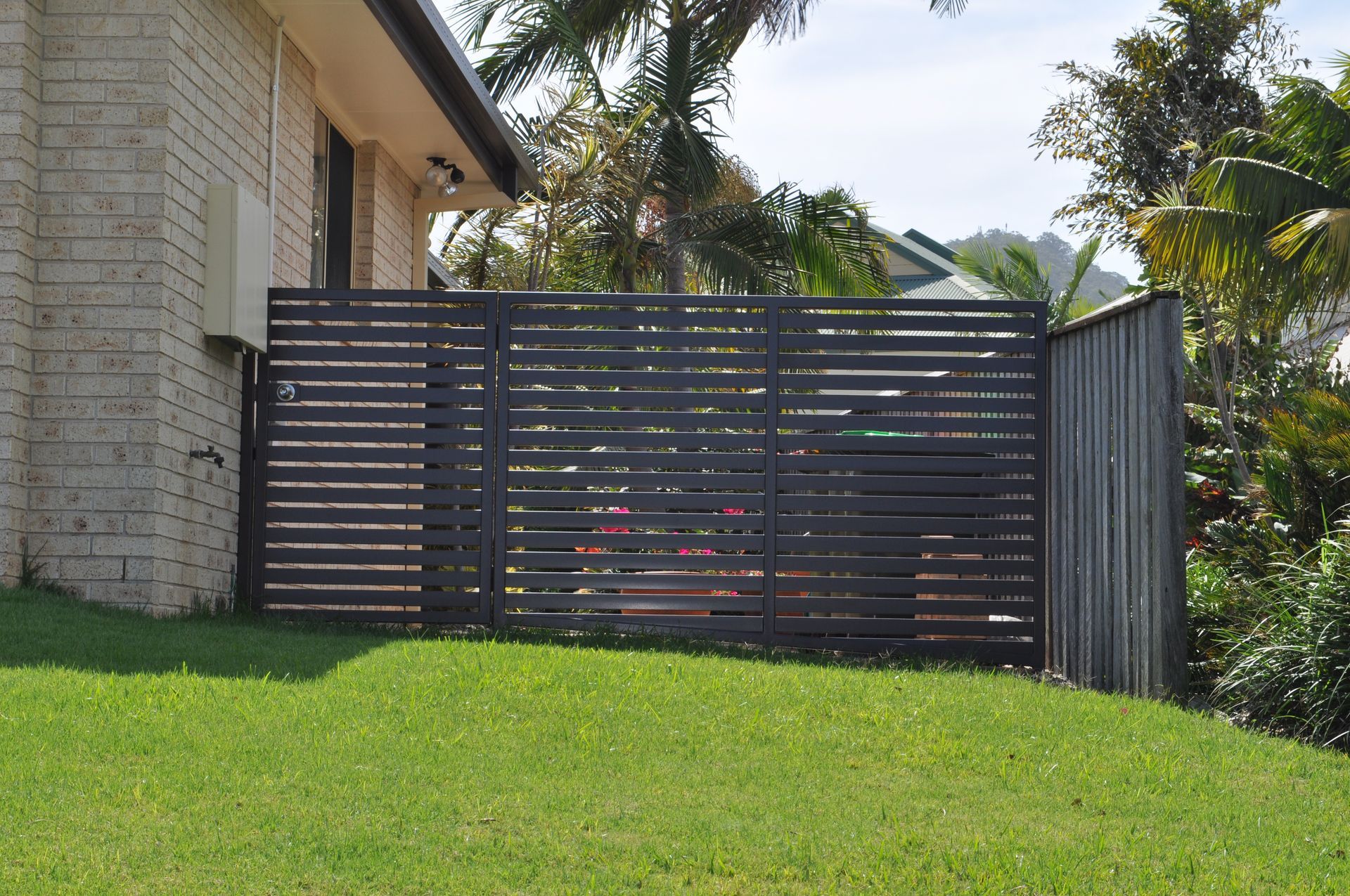 A house with a fence in front of it — Fabricator In Coffs Harbour, NSW