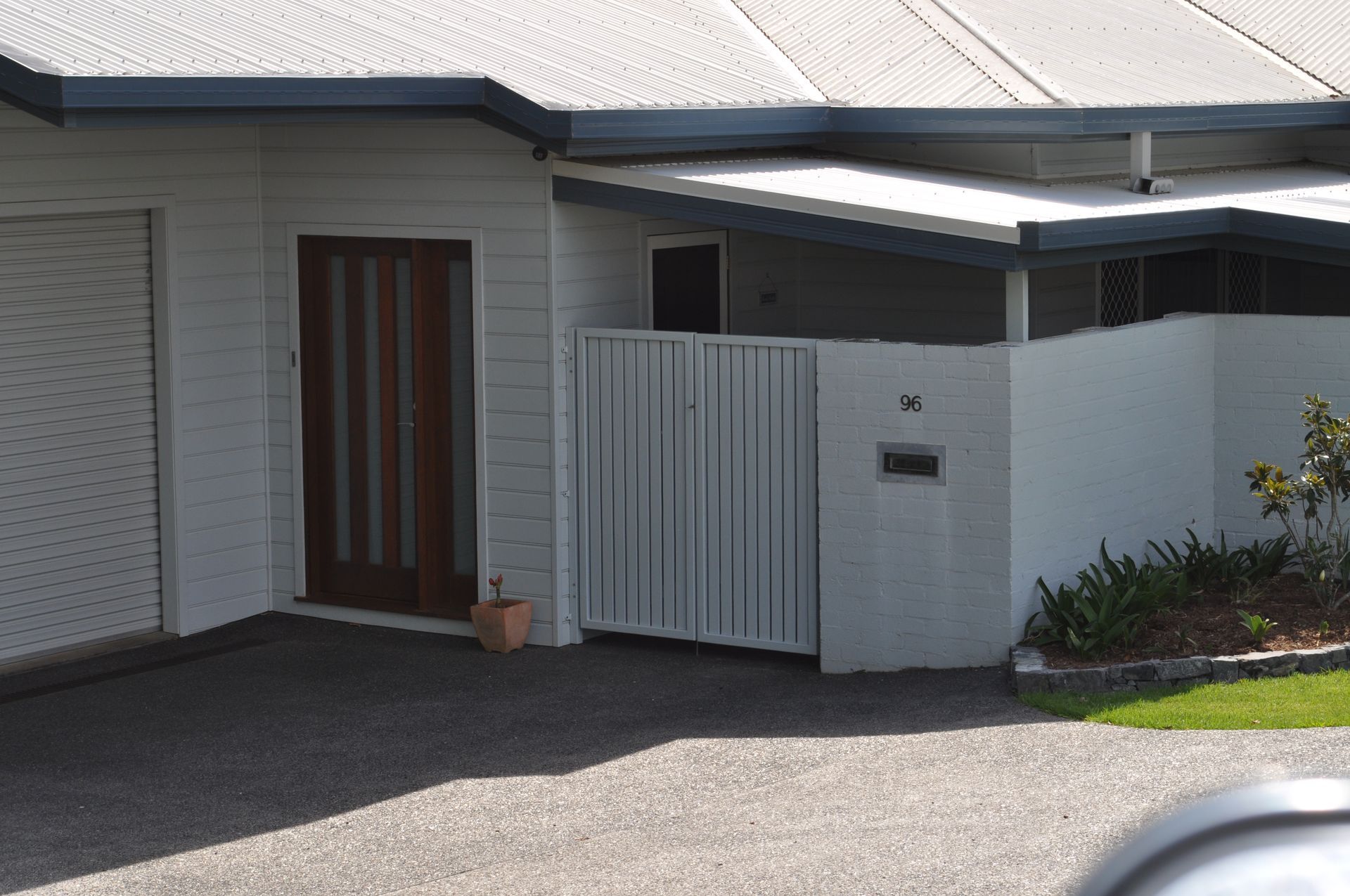 A white house with a brown door and a white gate — Fabricator In Coffs Harbour, NSW