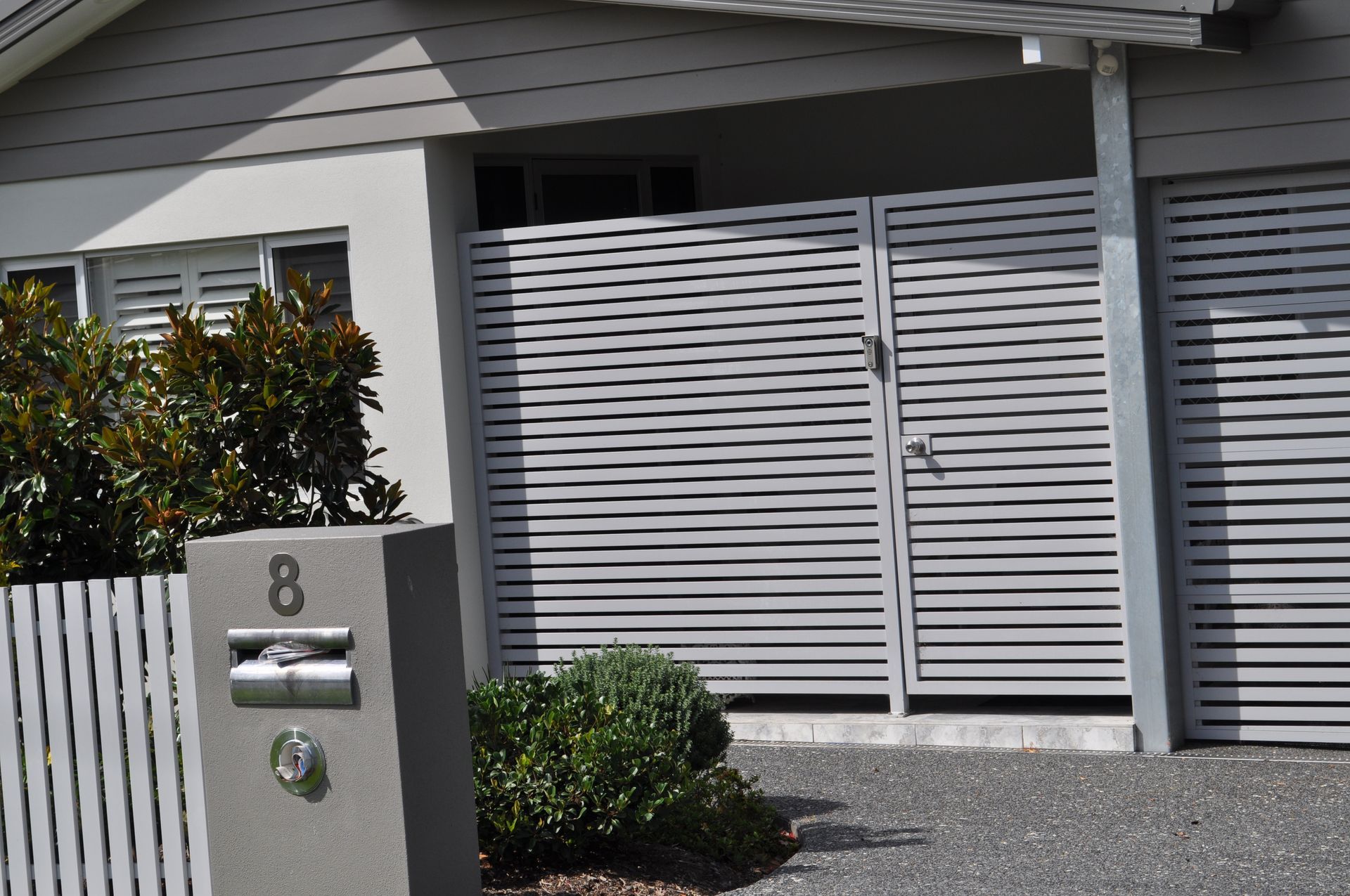 A house with a white fence and a mailbox with the number 8 on it — Fabricator In Coffs Harbour, NSW