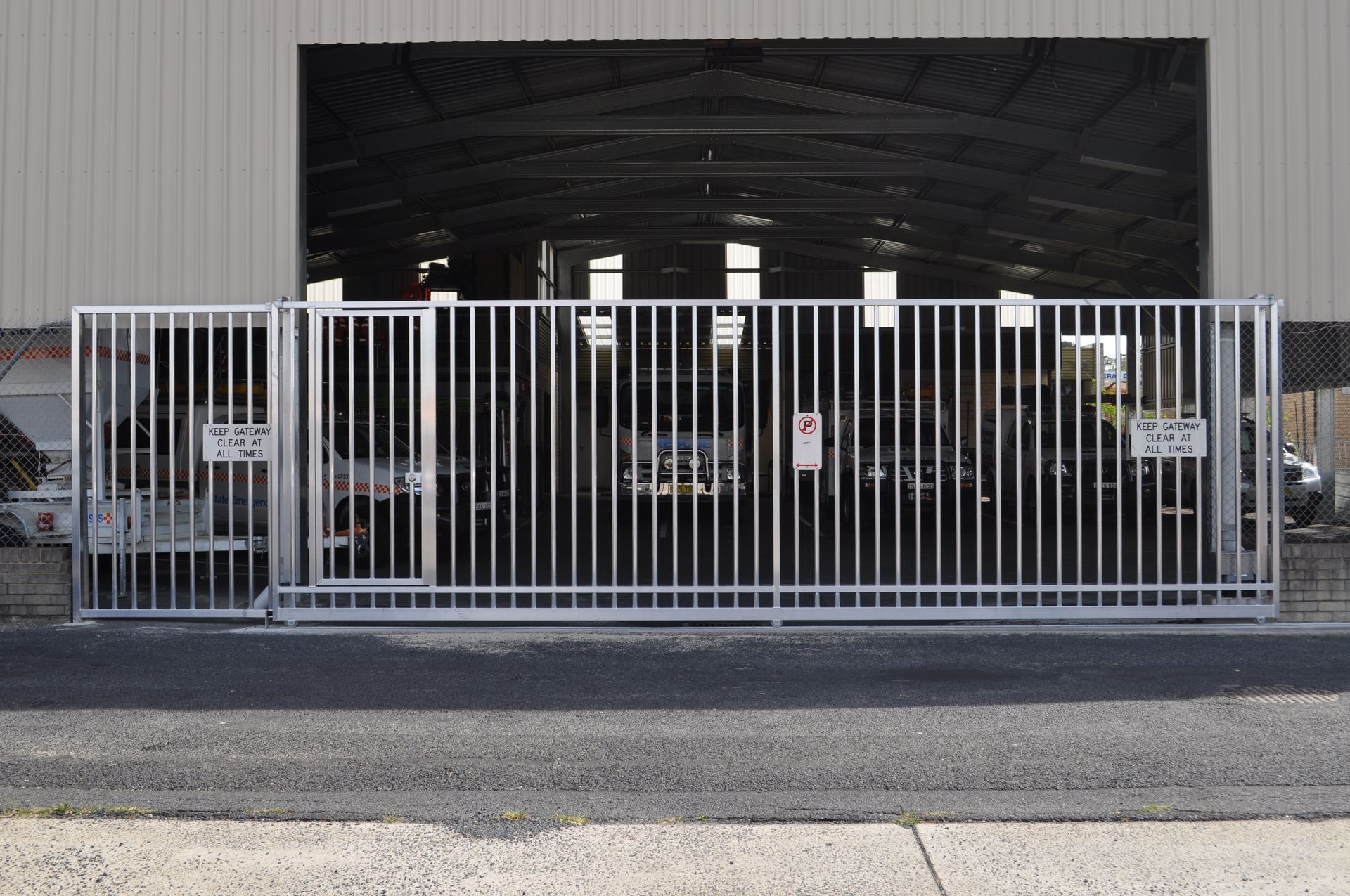 A sliding gate is sitting in front of a building — Fabricator In Coffs Harbour, NSW