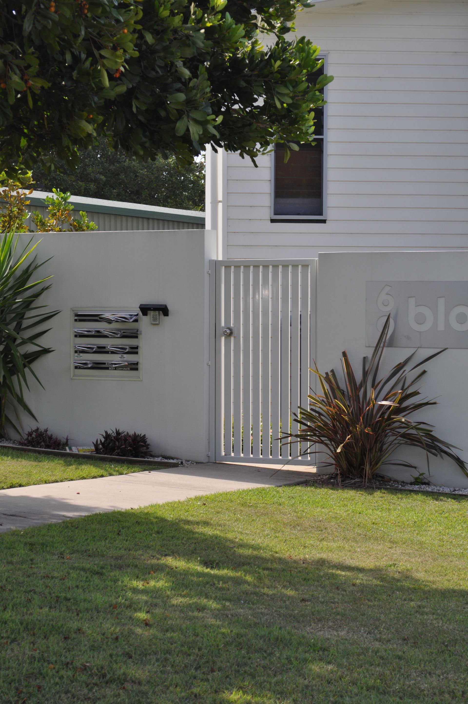 A white house with a white gate in front of it — Fabricator In Coffs Harbour, NSW