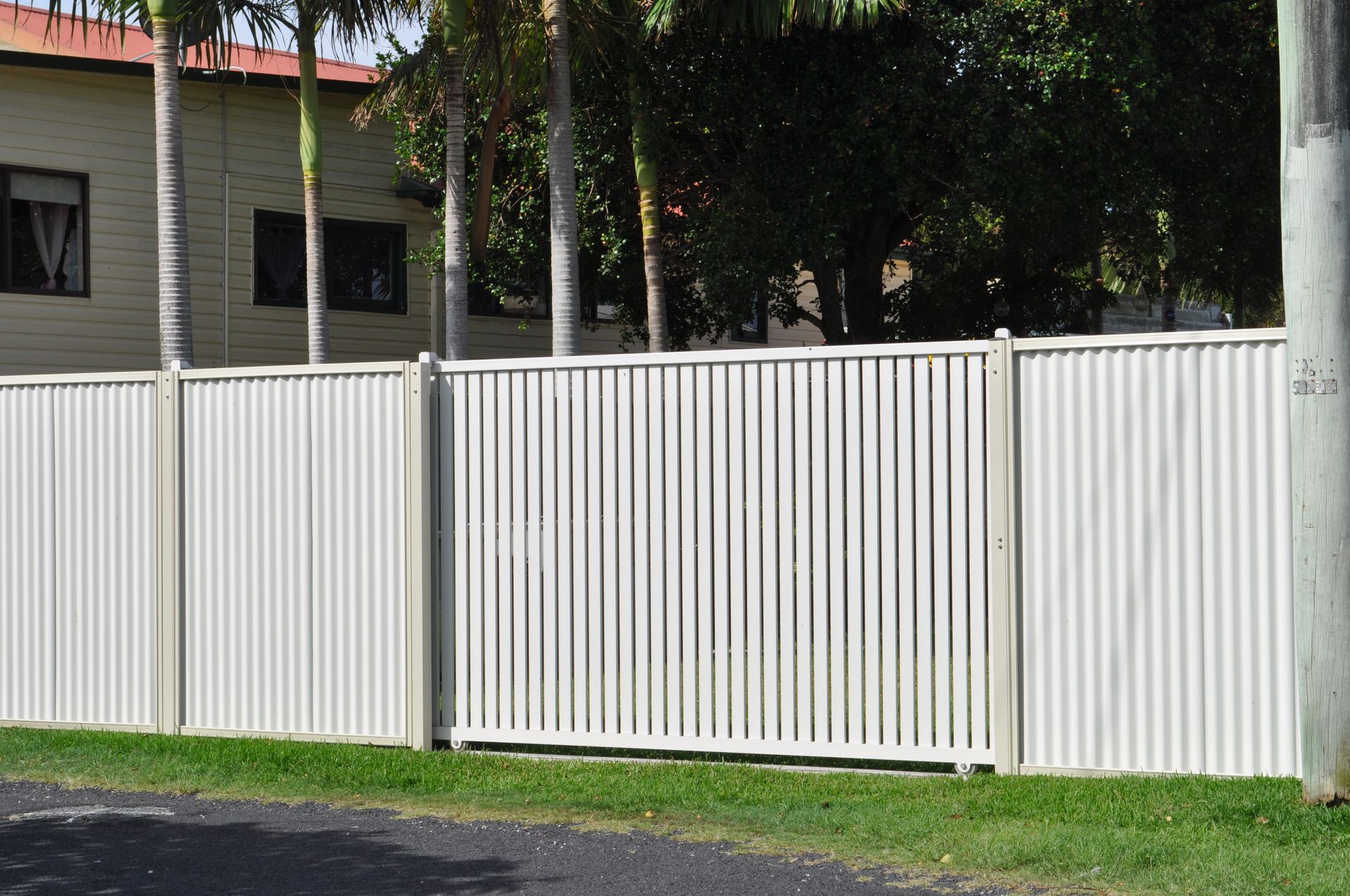 A white fence with palm trees in the background — Fabricator In Coffs Harbour, NSW