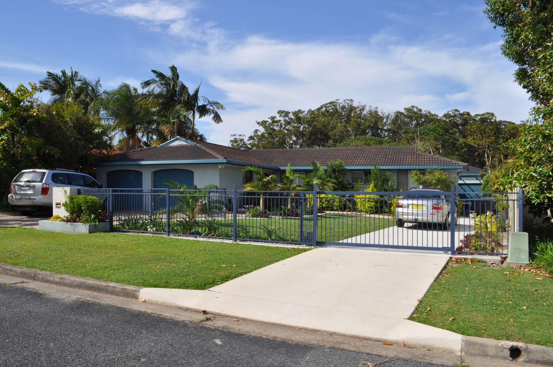 A white car is parked in front of a house — Fabricator In Coffs Harbour, NSW