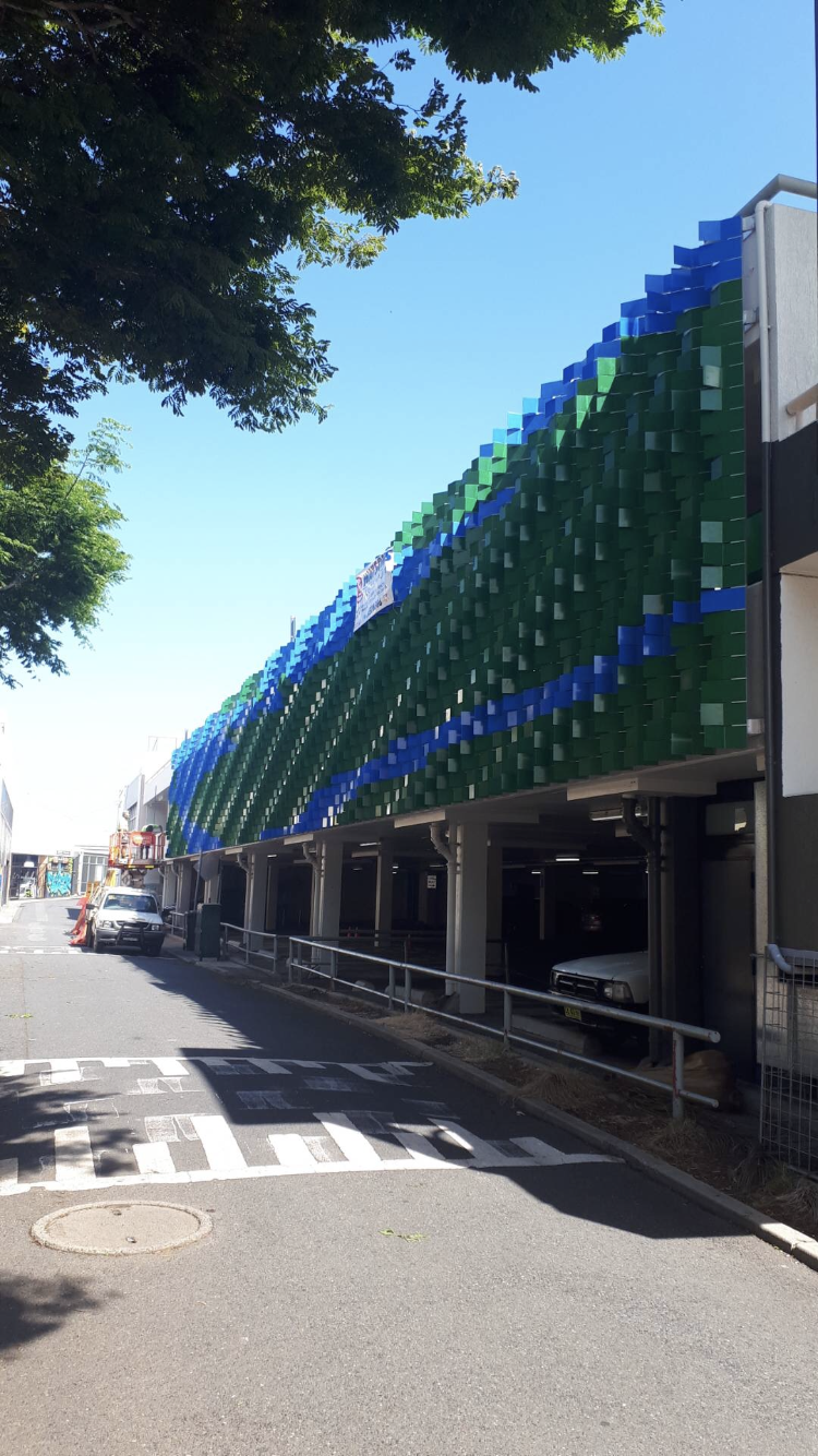 A parking garage with cars parked in front of it on a sunny day — Fabricator In Coffs Harbour, NSW