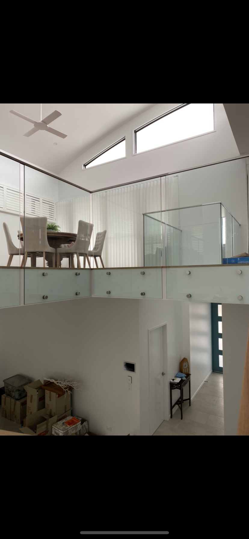 A dining room with a table and chairs and a glass railing — Fabricator In Coffs Harbour, NSW