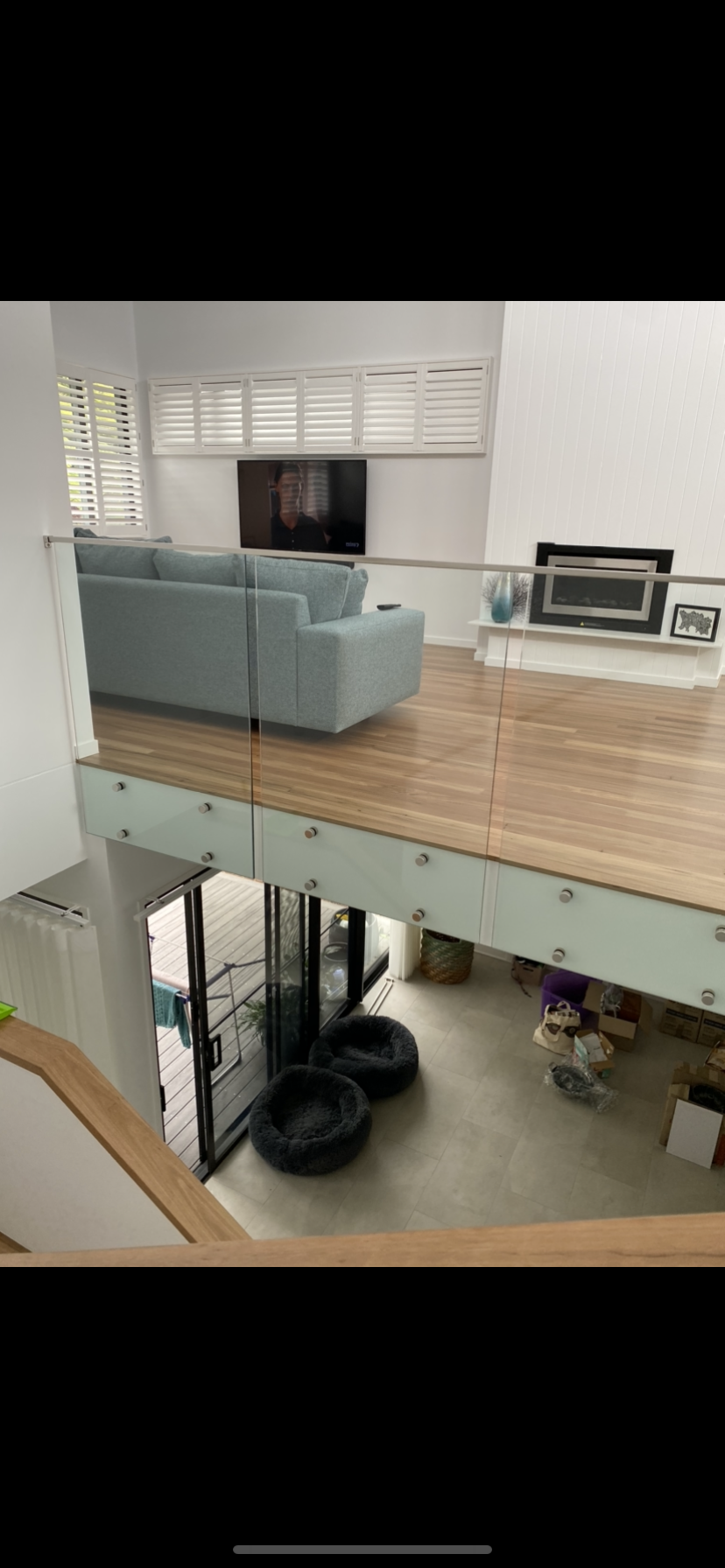 A living room with a blue couch and a fireplace.