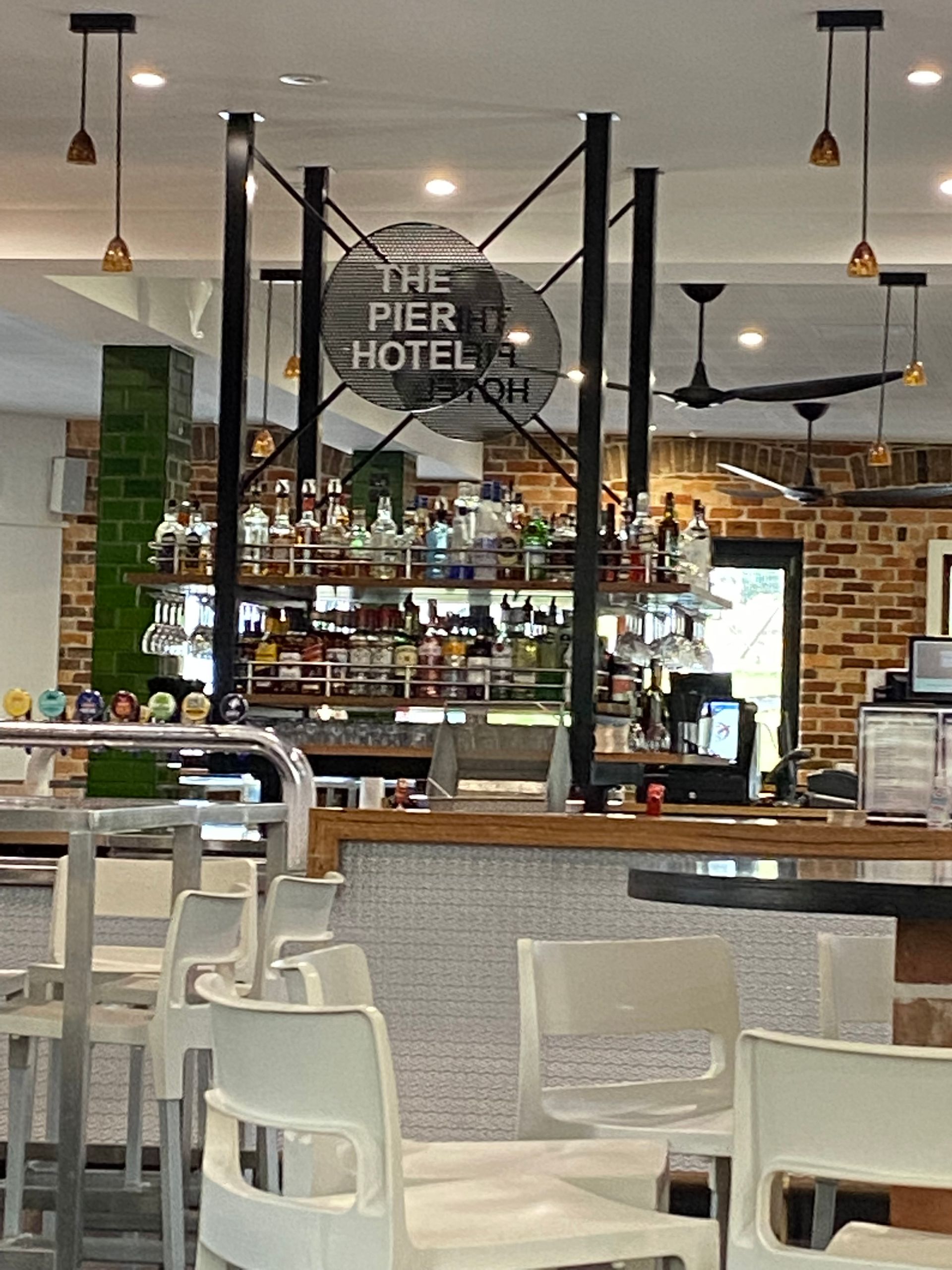 A restaurant with tables and chairs and a sign that says the pier hotel — Fabricator In Coffs Harbour, NSW