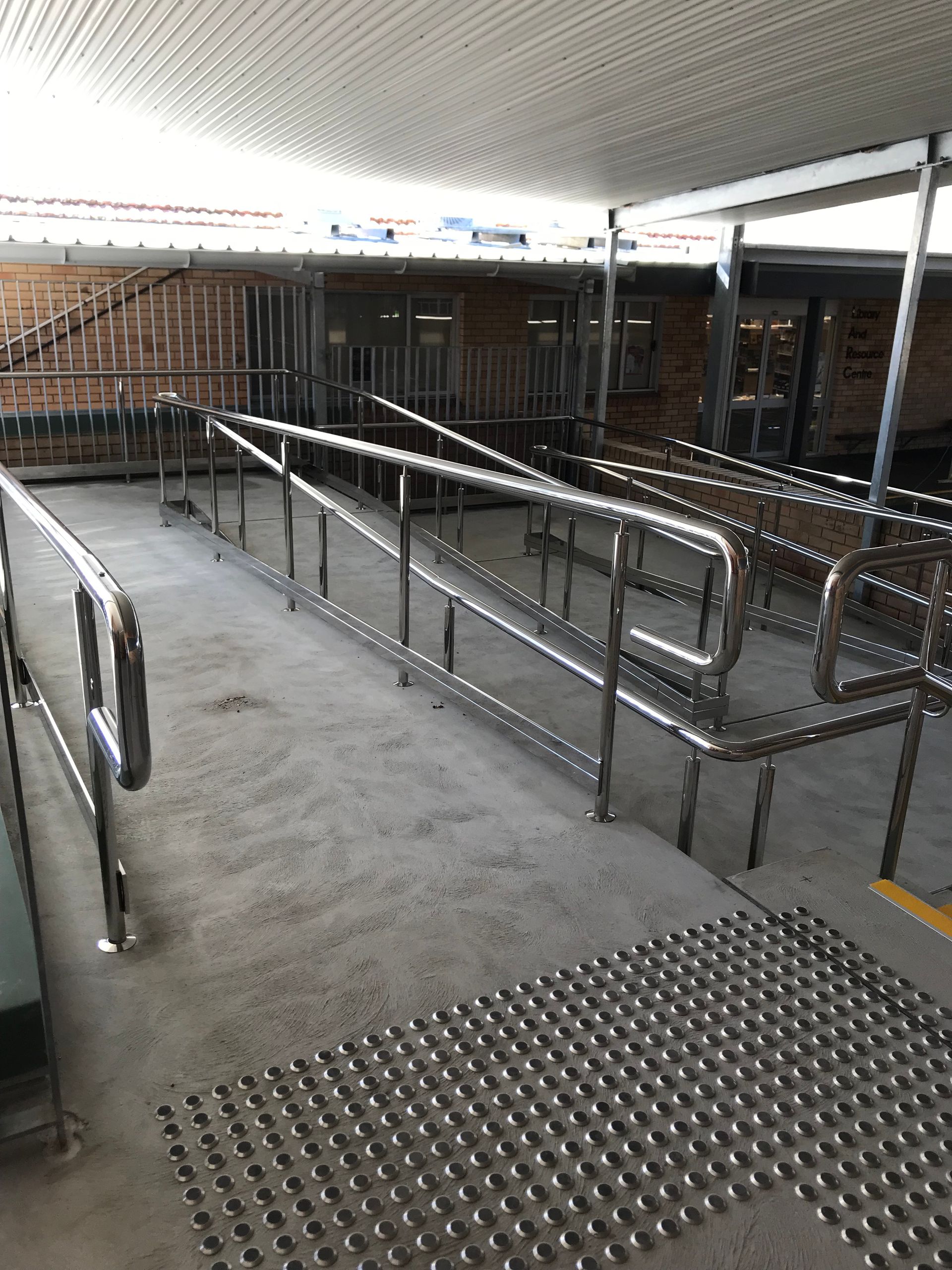 A handicapped ramp with a stainless steel railing in a building — Fabricator In Coffs Harbour, NSW