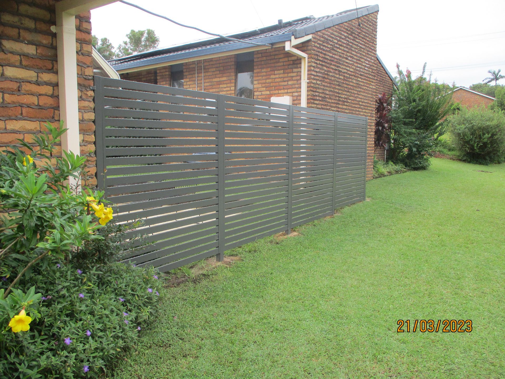 There is a fence in front of a brick house — Fabricator In Coffs Harbour, NSW