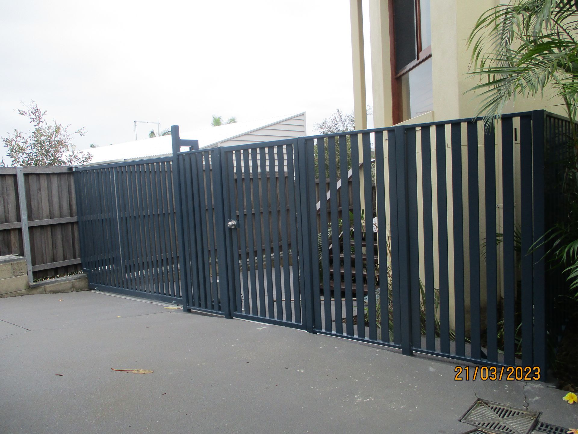 A fence with a gate in front of a building — Fabricator In Coffs Harbour, NSW