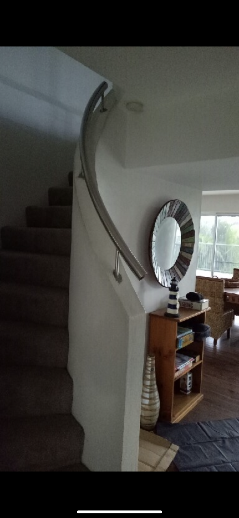 A spiral staircase in a house with a mirror on the wall — Fabricator In Coffs Harbour, NSW