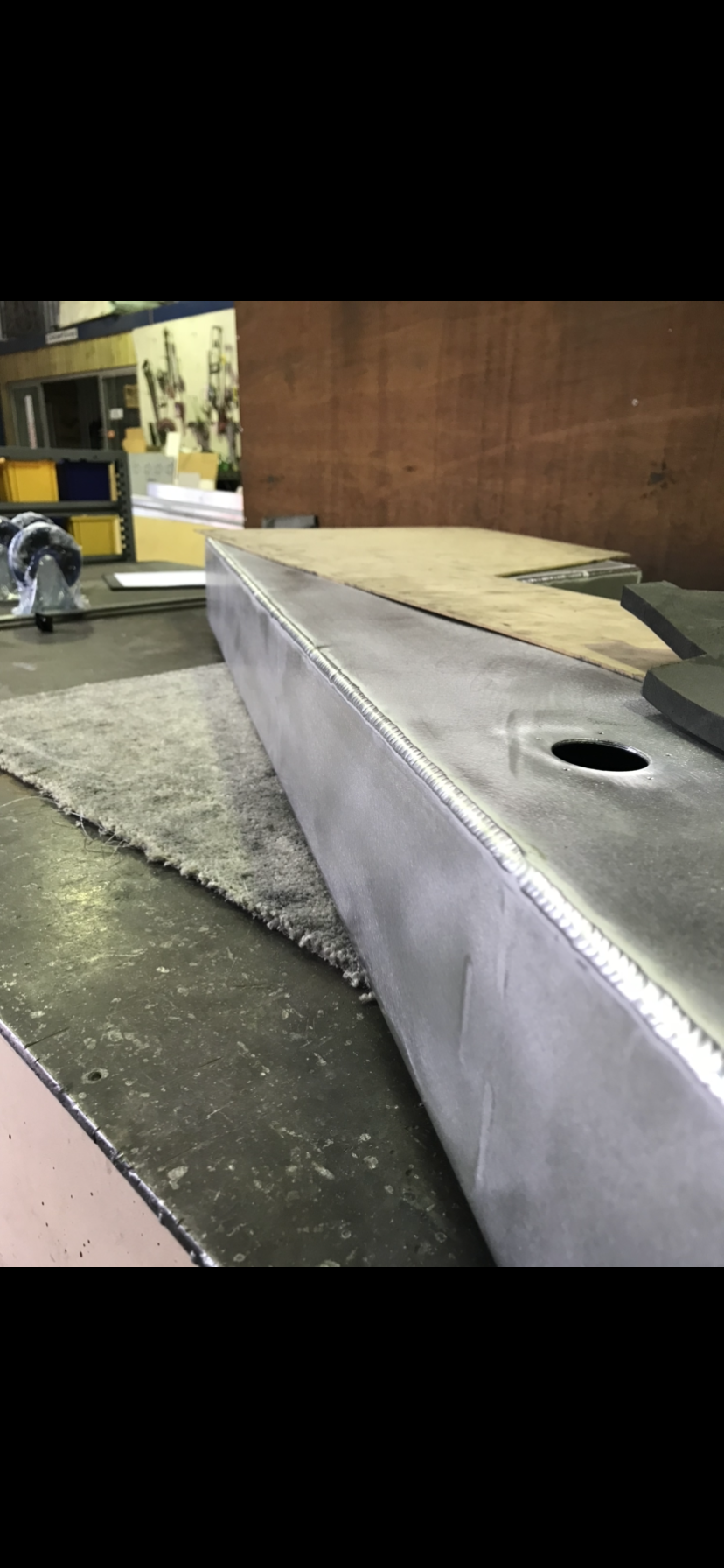 A piece of metal is sitting on top of a table in a factory — Fabricator In Coffs Harbour, NSW