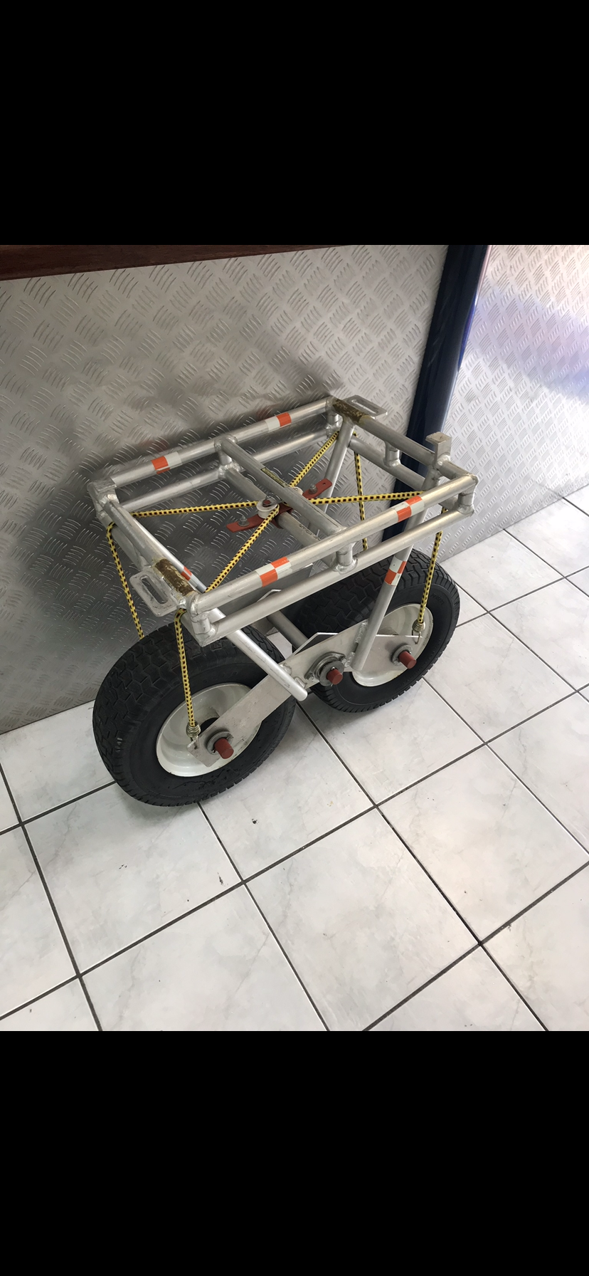 A small cart is sitting on a tiled floor next to a wall — Fabricator In Coffs Harbour, NSW