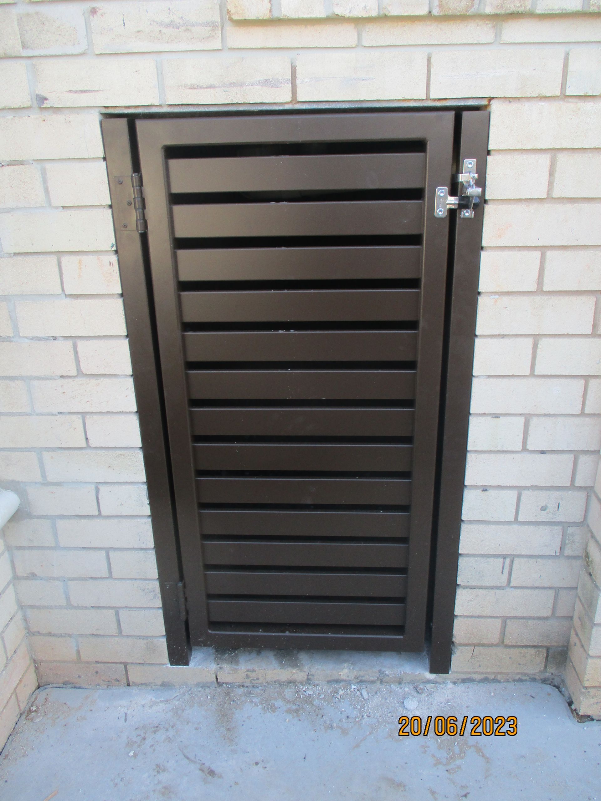 A brick wall with a wooden gate on it — Fabricator In Coffs Harbour, NSW