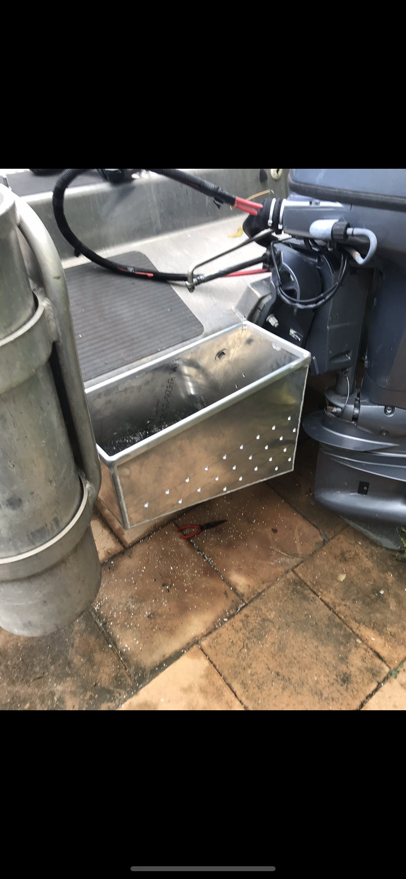A boat is parked on a brick sidewalk next to a metal box — Fabricator In Coffs Harbour, NSW