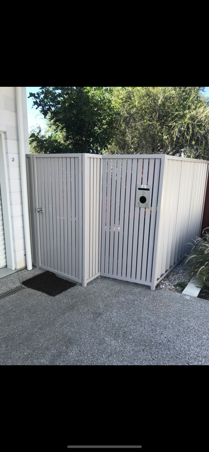 A white fence with a gate in front of a house — Fabricator In Coffs Harbour, NSW