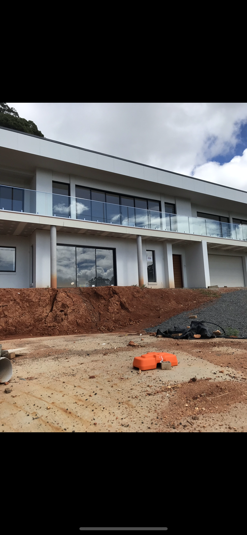 A large white house is being built on top of a dirt hill — Fabricator In Coffs Harbour, NSW