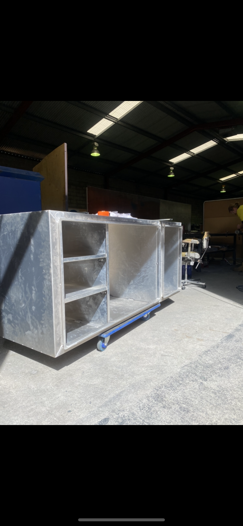 A large metal box is sitting on top of a concrete floor in a warehouse — Fabricator In Coffs Harbour, NSW