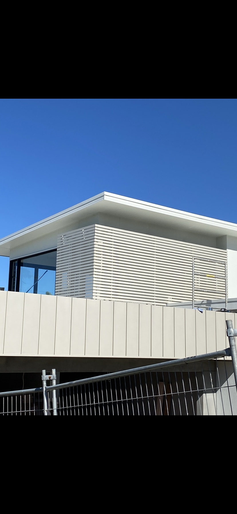 A large white building with a blue sky in the background — Fabricator In Coffs Harbour, NSW