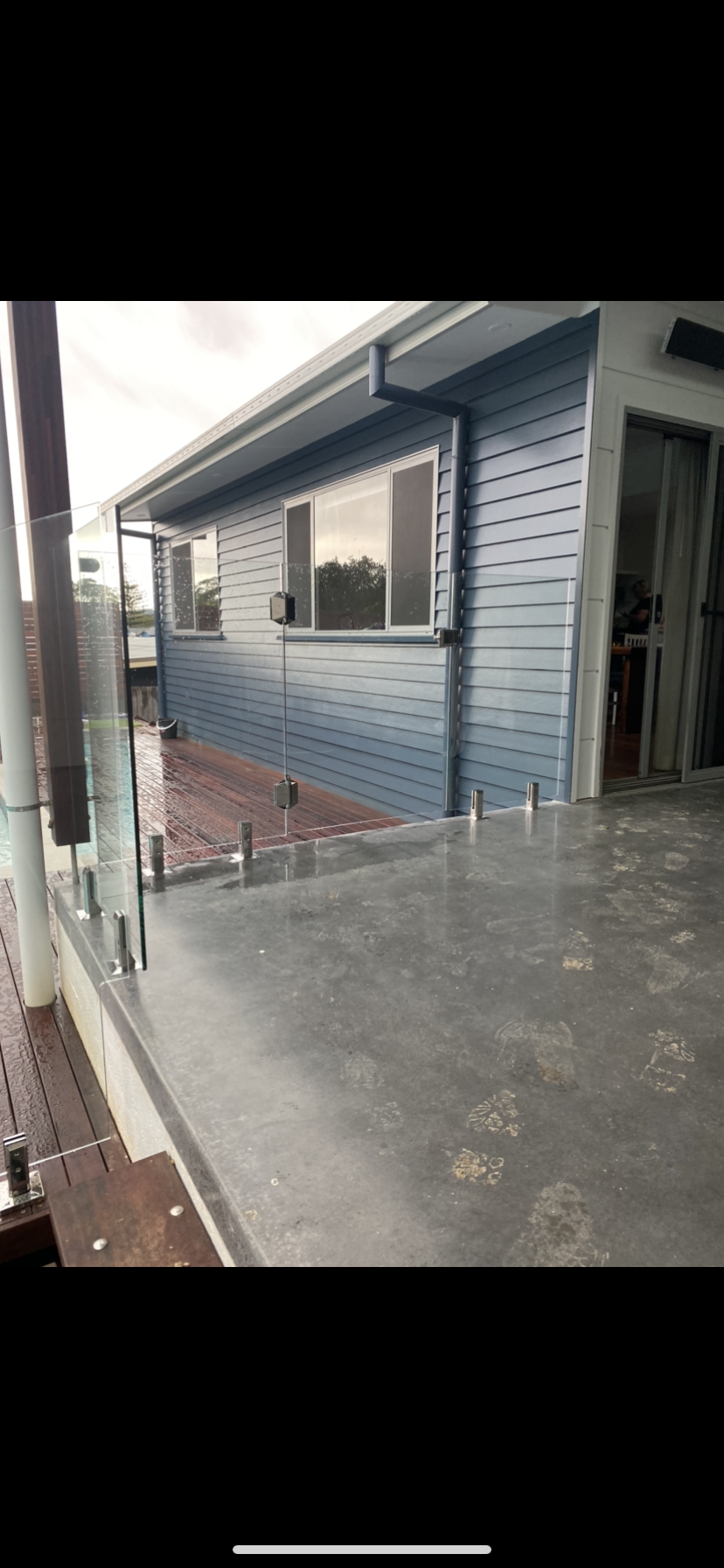A blue house with a concrete deck and a glass railing — Fabricator In Coffs Harbour, NSW