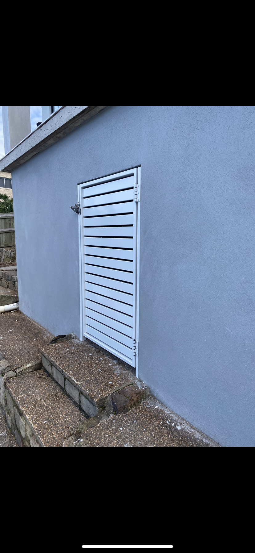 A white gate is attached to the side of a building — Fabricator In Coffs Harbour, NSW