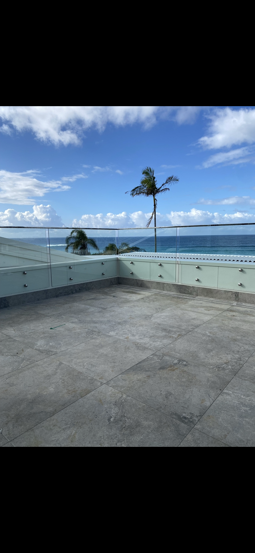 Swimming Pool With Glass Pool Fence In The Backyard — Fabricator In Coffs Harbour, NSW