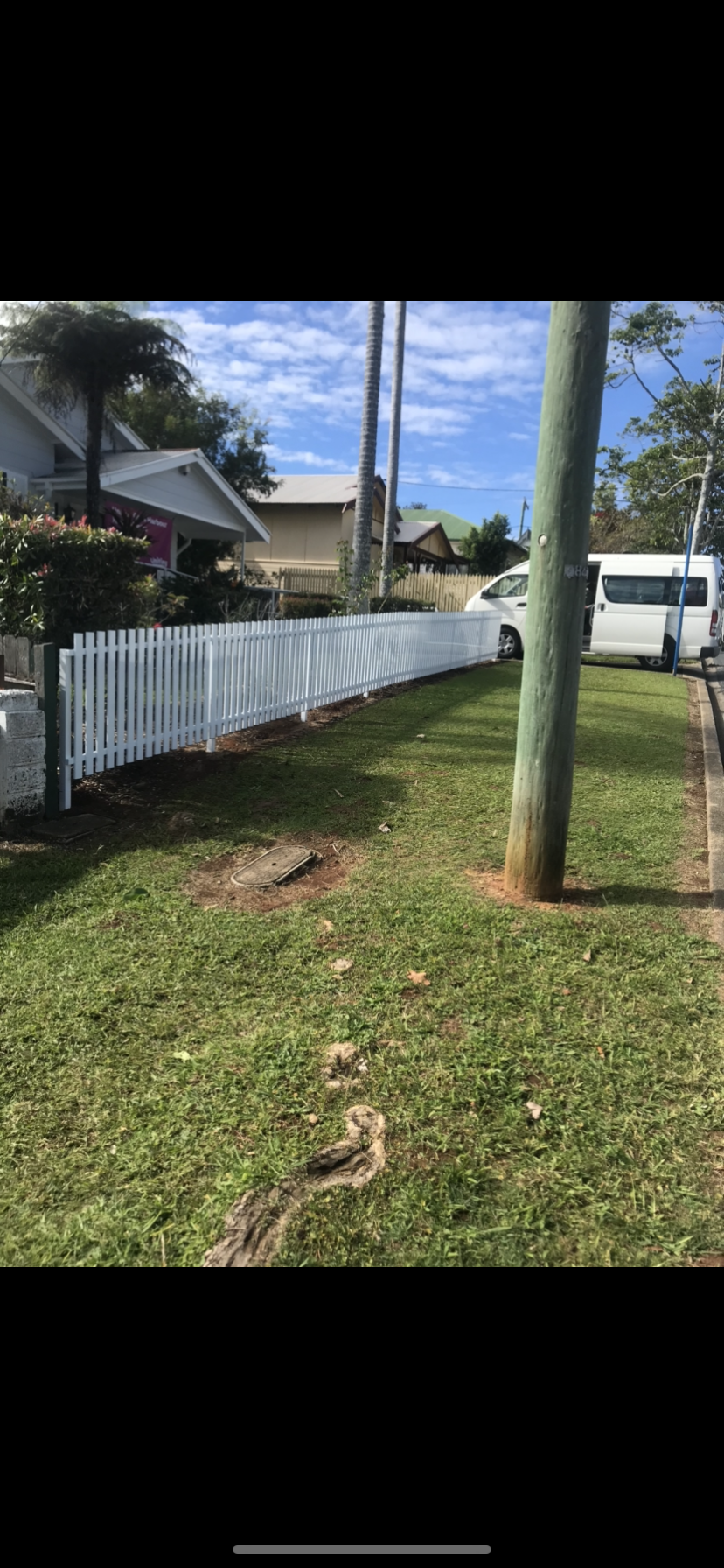 A white picket fence surrounds a lush green yard — Fabricator In Coffs Harbour, NSW