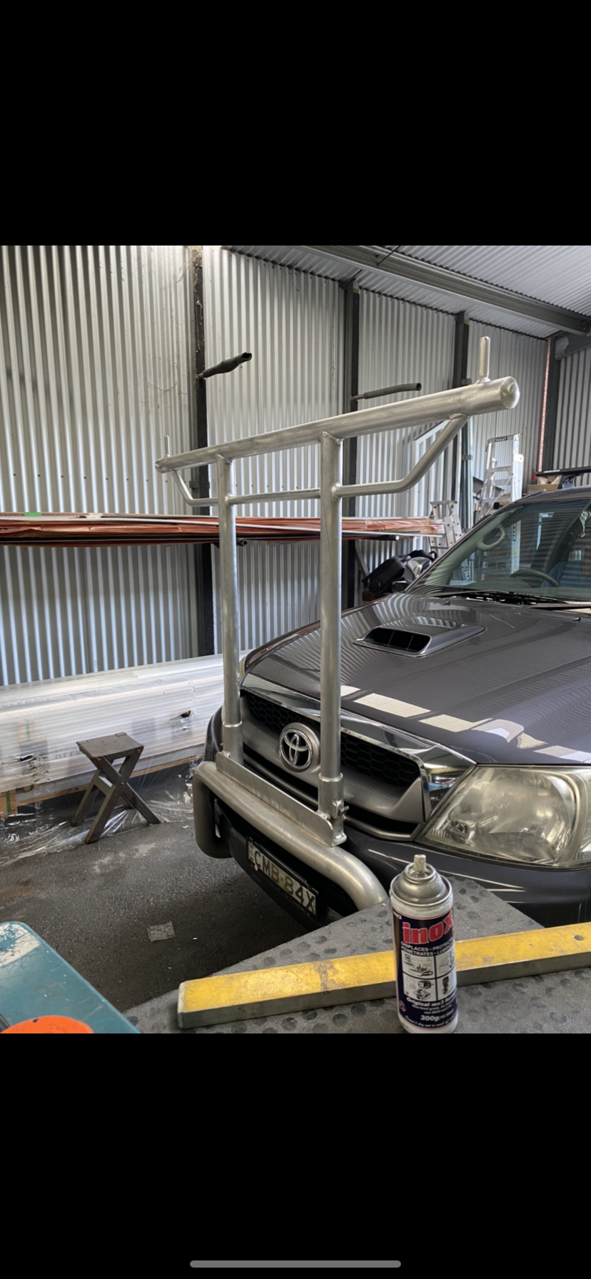 A car is parked in a garage next to a can of spray paint — Fabricator In Coffs Harbour, NSW