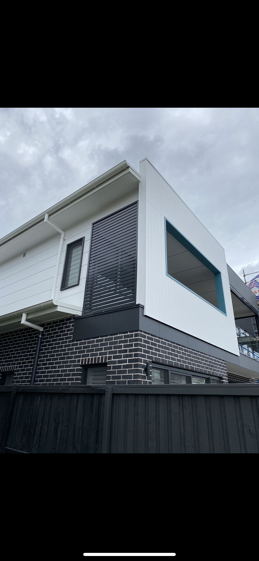 A white house with a black fence in front of it — Fabricator In Coffs Harbour, NSW