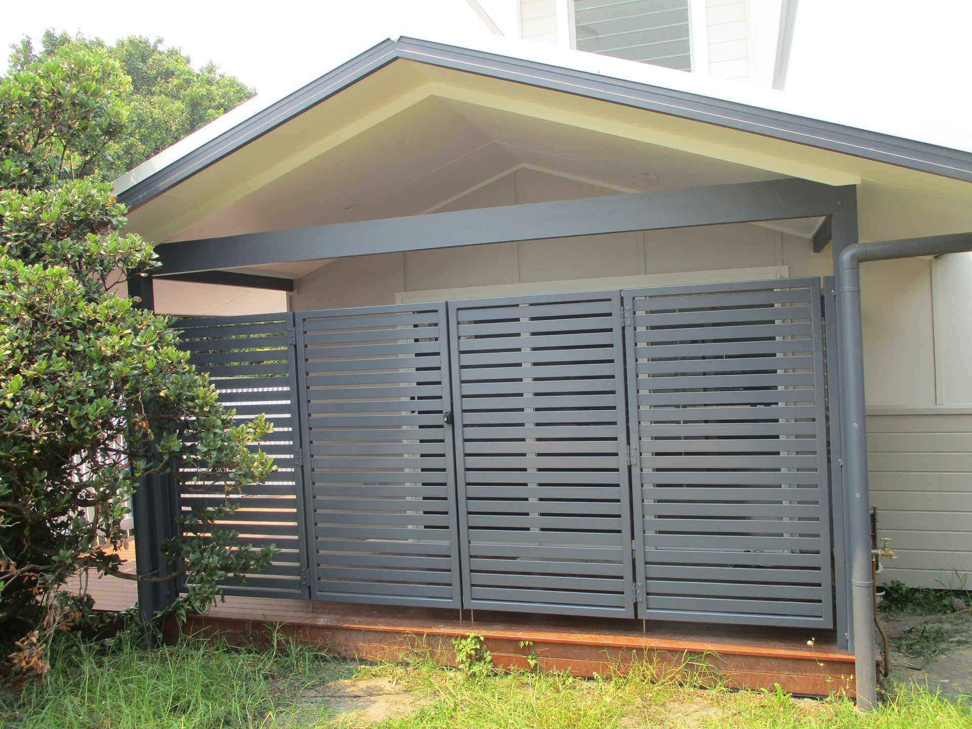 A house with a fence in front of it and a roof — Fabricator In Coffs Harbour, NSW