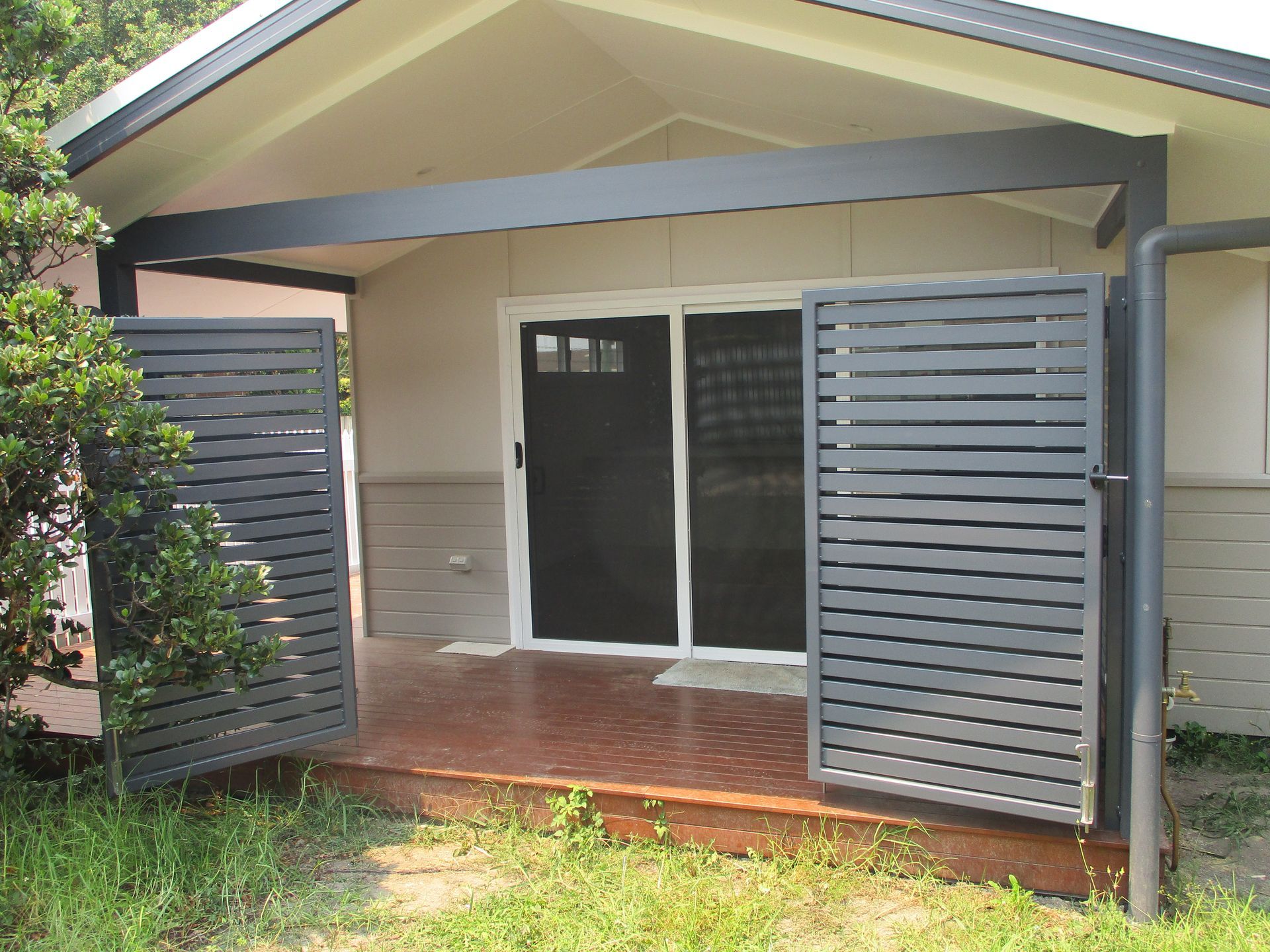 A house with a fence and a sliding glass door — Fabricator In Coffs Harbour, NSW