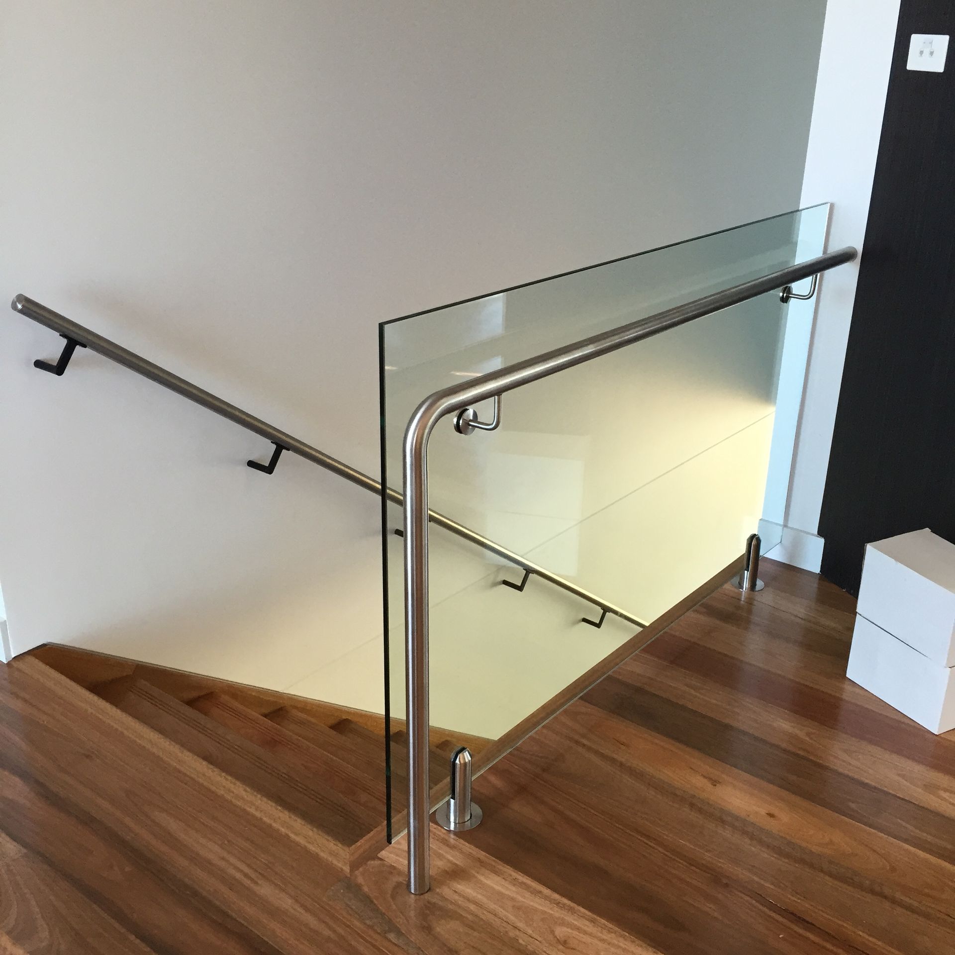 A staircase with a glass railing and wooden steps — Fabricator In Coffs Harbour, NSW